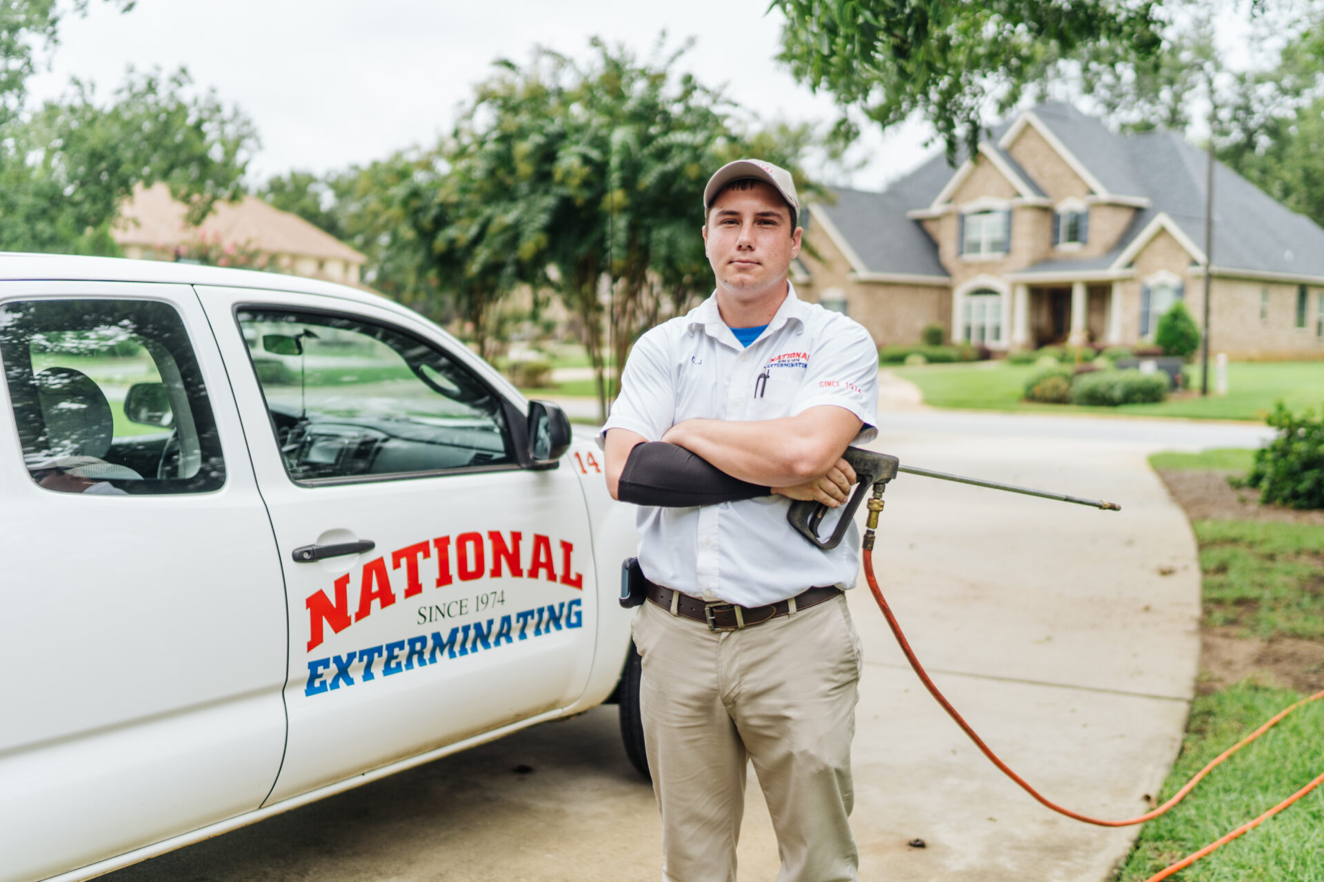 man standing beside company truck